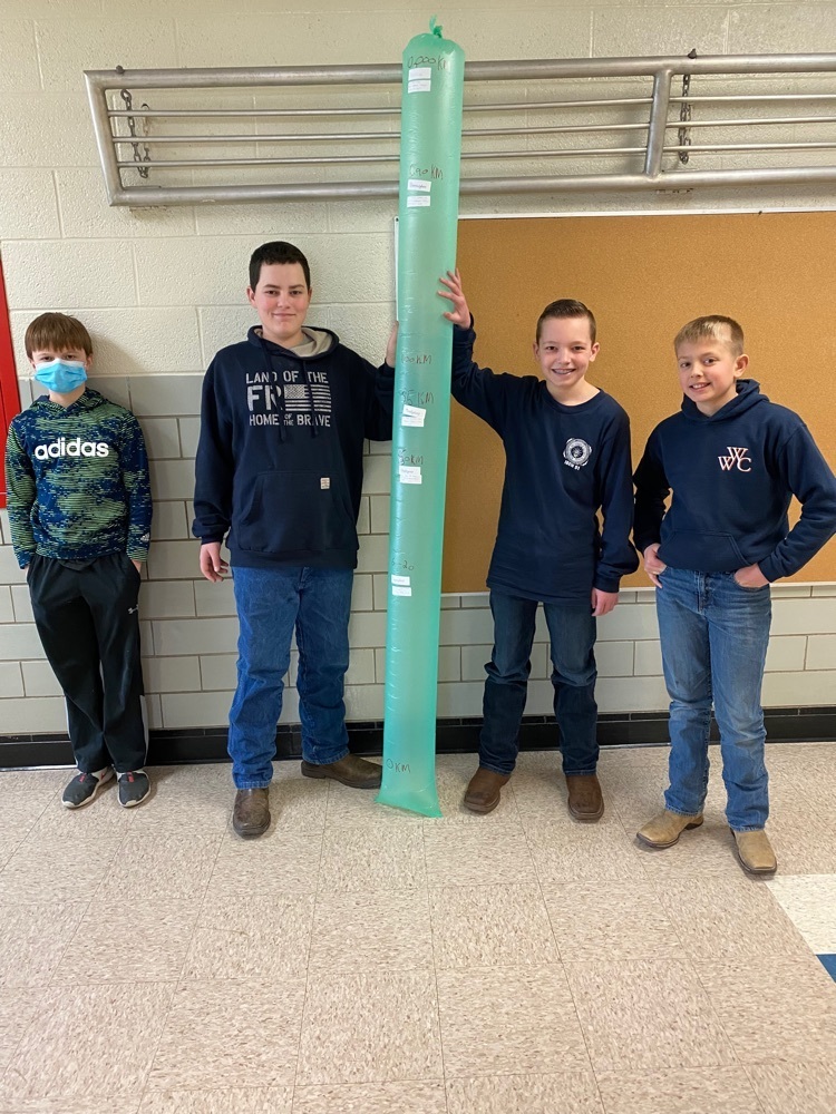 group of students standing with their Bernoulli bag model of the atmosphere